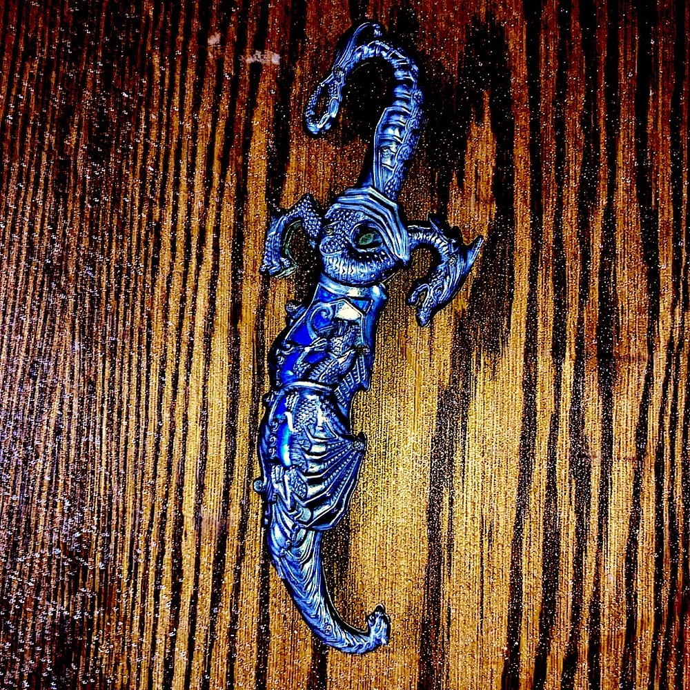 Dragon dagger. As long as my fore arm. Sharp. Almost new.